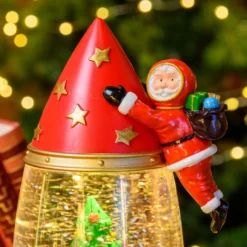 Lanterna Razzo con Babbo Natale astronauta, rosso e oro, h 27,5 cm, led bianco caldo