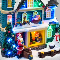 Villaggio di Natale, Casa con scena natalizia, Slitta in movimento e Albero di Natale RGB, h 23 cm, musiche natalizie