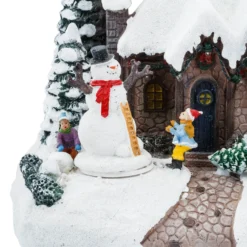 Villaggio di Natale, Casa innevata nel Bosco con Pupazzo di Neve rotante, h 20 cm, musiche natalizie