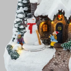 Villaggio di Natale, Casa innevata nel Bosco con Pupazzo di Neve rotante, h 20 cm, musiche natalizie