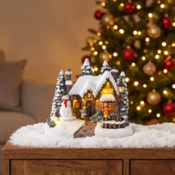 Villaggio di Natale, Casa innevata nel Bosco con Pupazzo di Neve rotante, h 20 cm, musiche natalizie