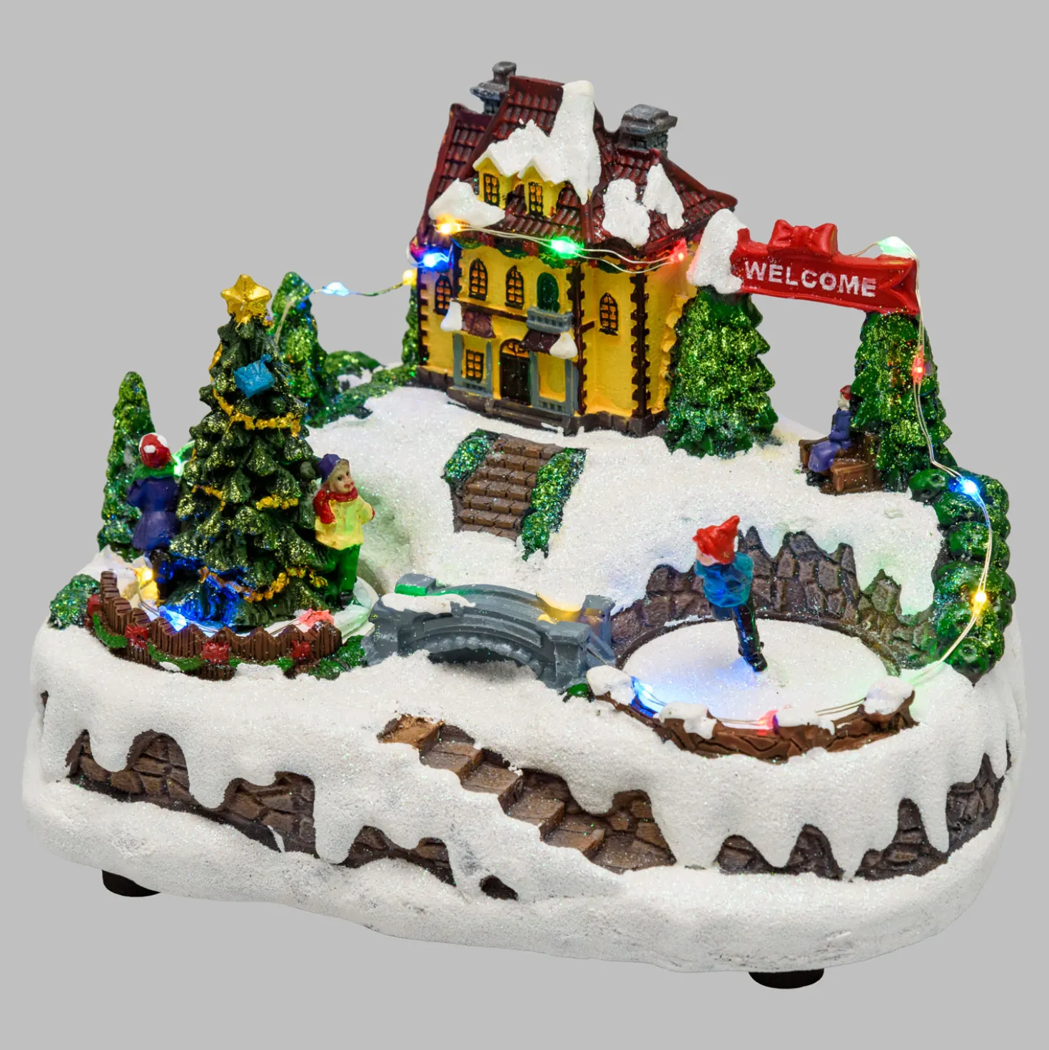 Villaggio di Natale in Polyresina, Pattinatore e Albero Natale con Bambini rotanti, h 15 cm