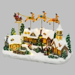 Villaggio Innevato con Chiesa e Babbo Natale su Slitta Volante con Renne in movimento, h 23 cm, musiche natalizie