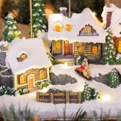 Villaggio Innevato con Chiesa e Babbo Natale su Slitta Volante con Renne in movimento, h 23 cm, musiche natalizie