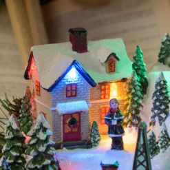 Villaggio innevato di Natale e Trenino con movimento rotante, h 22 cm, musiche natalizie
